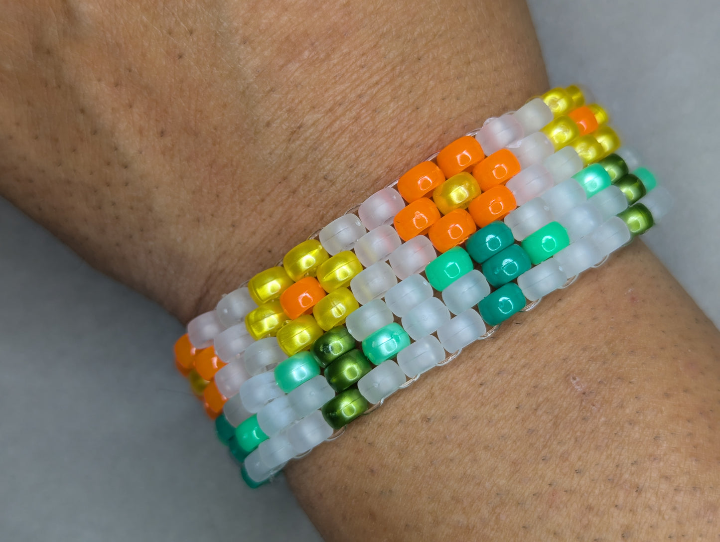 Orange and Yellow Flower Bracelet with Frosted White Background (Black Light Active)