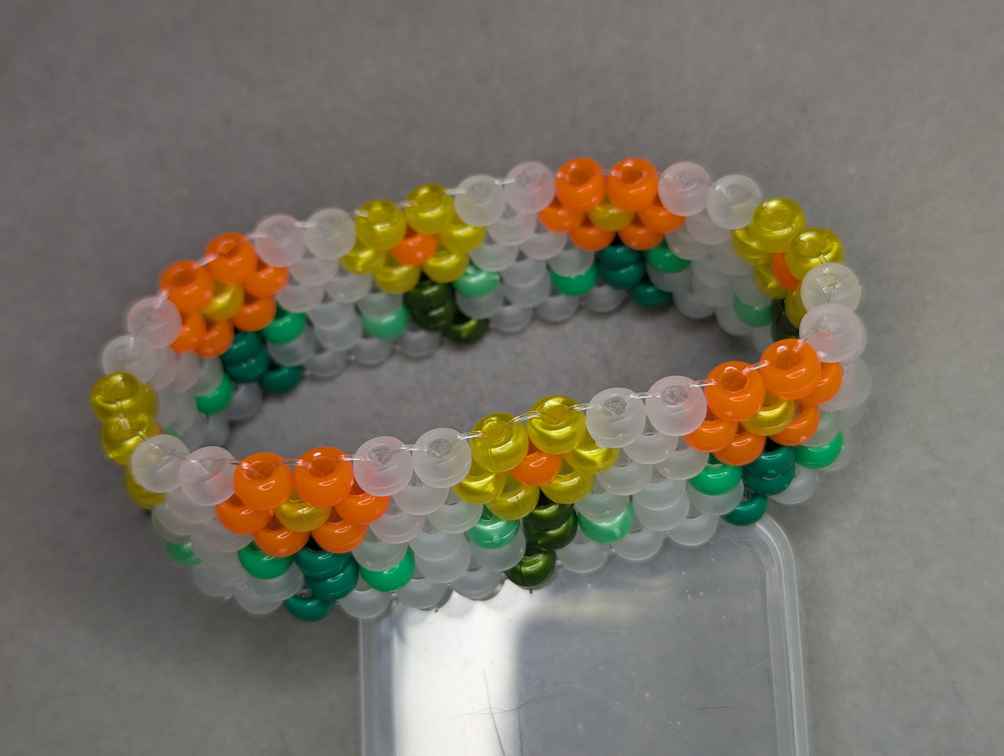 Orange and Yellow Flower Bracelet with Frosted White Background (Black Light Active)